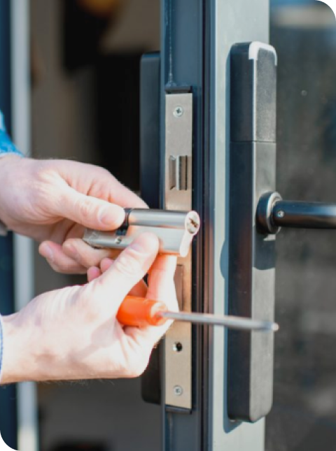 Locksmith installing deadbolt on door