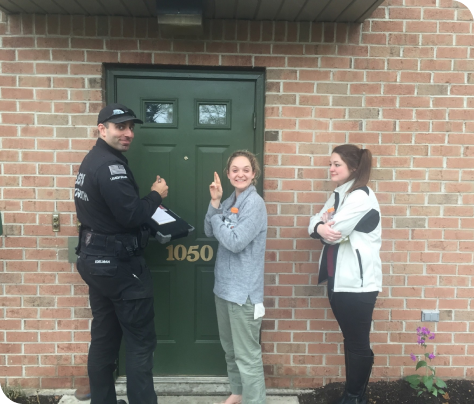 locksmith with satisfied customers in front of residential door