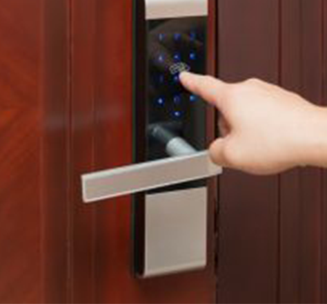 a finger touching a numerical keypad