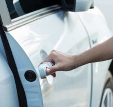 a hand opening a cardoor