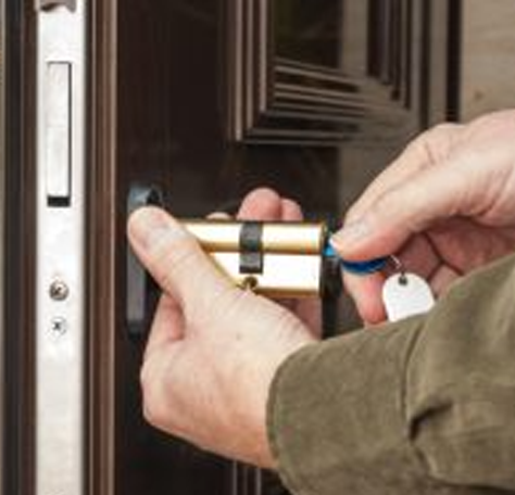 a locksmith tests a deadbolt key