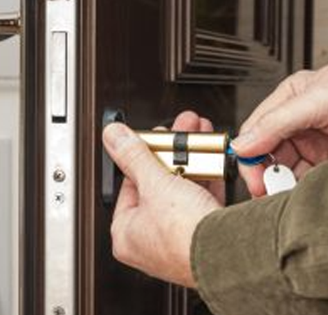 a locksmith testing a deadbolt with a key