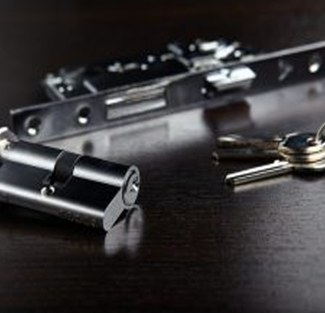 a ring of keys and a deadbolt on a table
