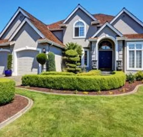 a residential mansion with well-trimmed hedgerows