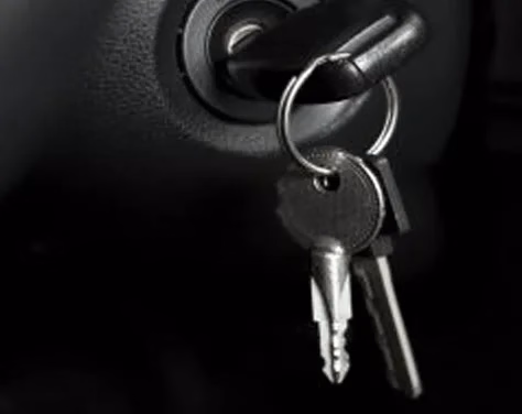 a car key dangles from the ignition