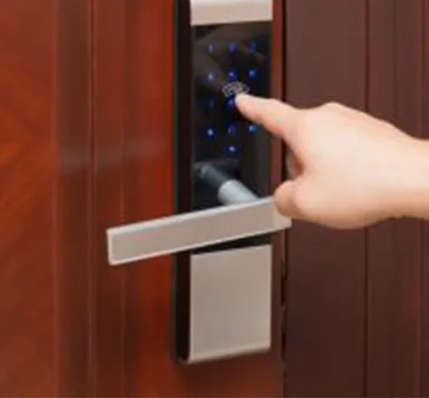 a finger touching a numerical keypad