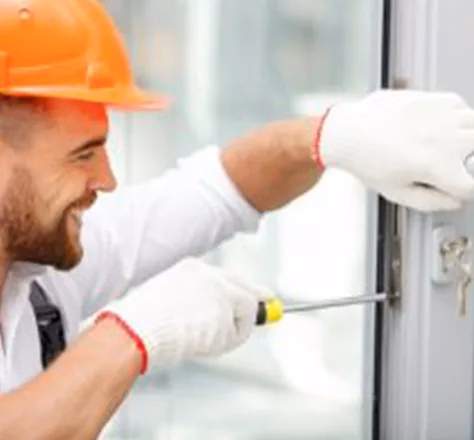 a happy locksmith installing a lock commercial locksmith services