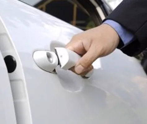 a man opening a car door by the handle
