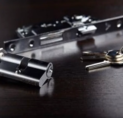 a ring of keys and a deadbolt on a table