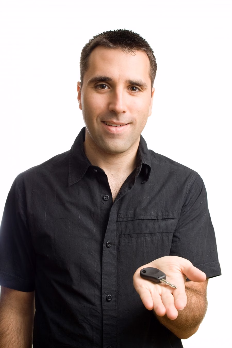 Man holding out a car key in his open hand
