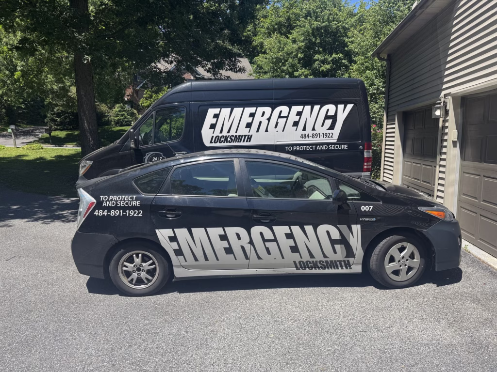 Emergency Locksmith van and service car in a driveway