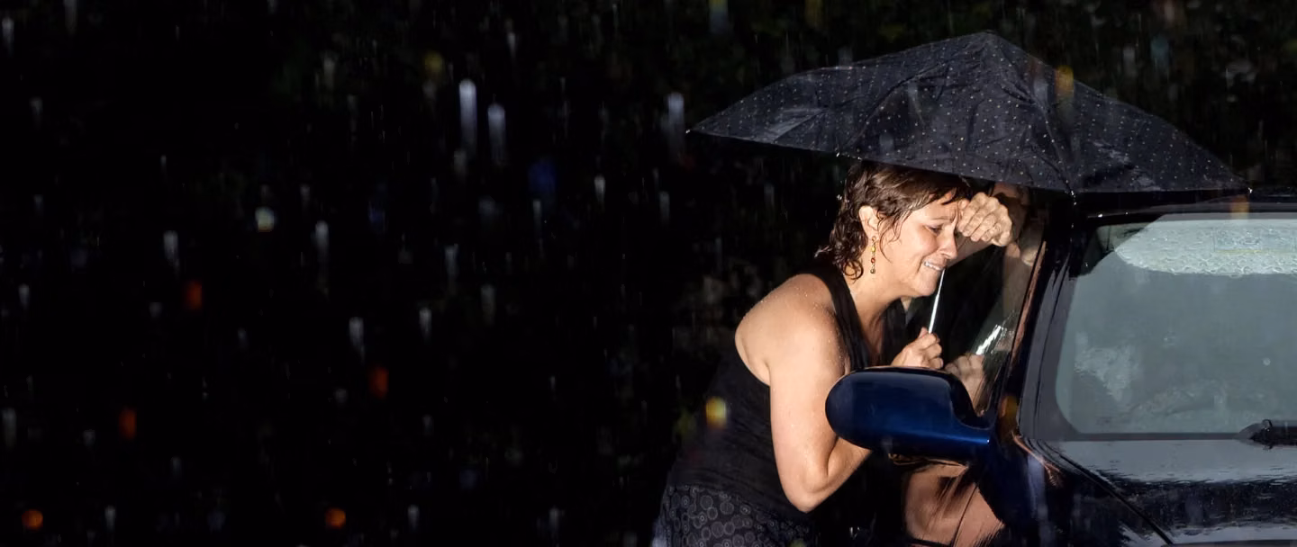 Woman locked out of her car in the rain