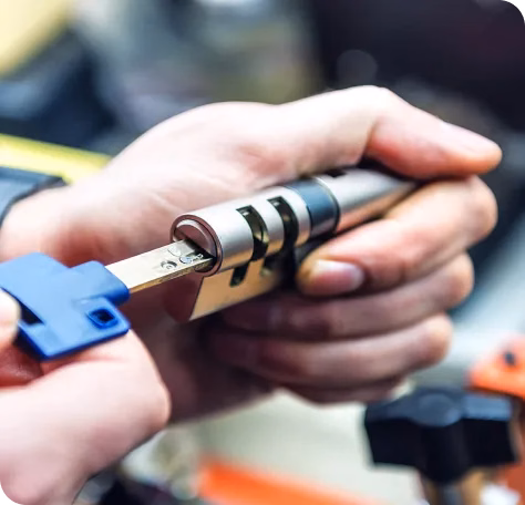 locksmith holding key in lock tumbler