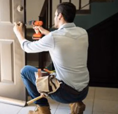 A locksmith repairing a lock